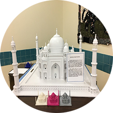 Taj Mahal model from the Ohio State School for the Blind historic landmark model collection with four smaller 3D printed Taj Mahal models (dodo2000, 2015) printed by students in the OSSB Model Club. A large print and braille description written by students is also included to give historical context for the model.